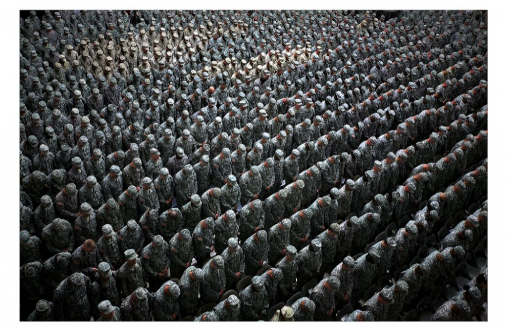 Ashley Gilbertson 1,215 American soldiers, airmen, Marines and sailors pray before a pledge of enlistment on July 4, 2008, at a massive re-enlistment ceremony at one of Saddam Hussein's former palaces in Baghdad, Iraq 2008 from Whiskey Tango Foxtrot series type C photograph 69.0 x 94.0 x 5.5 cm Courtesy of the artist © Ashley Gilbertson / VII Network